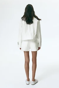 Raw-edge denim shorts