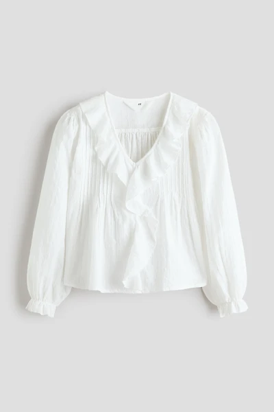 Blouse en plumetis avec bords à volants