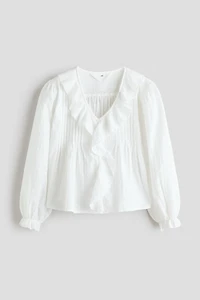 Blouse en plumetis avec bords à volants