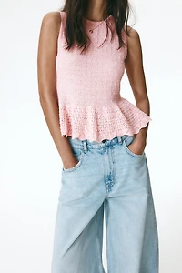 Haut péplum en tricot pointelle