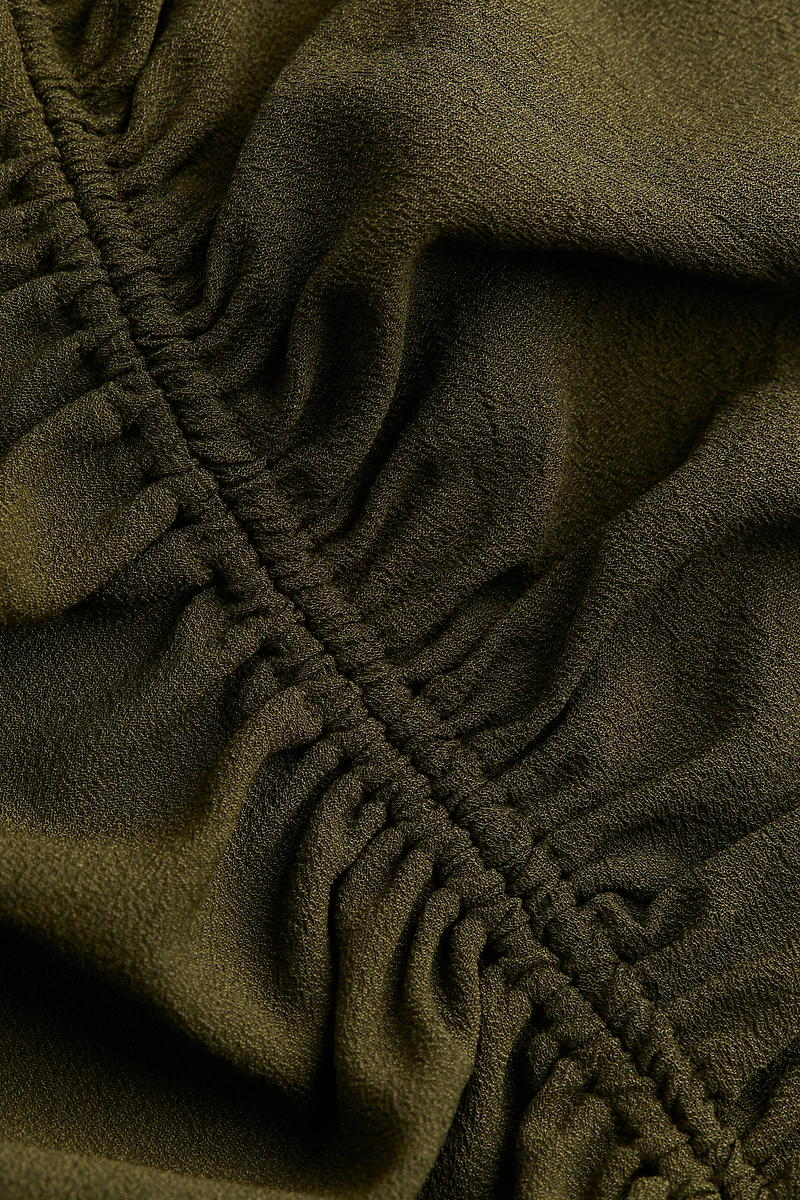 Robe asymétrique à effet drapé