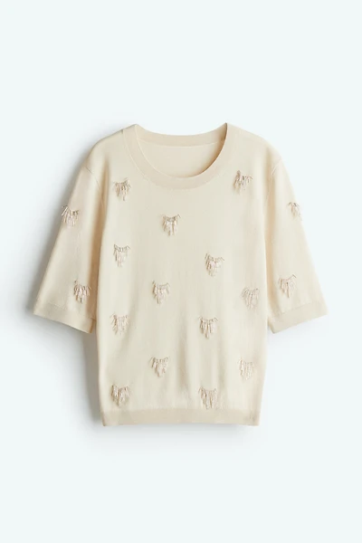 Haut orné de perles fantaisie