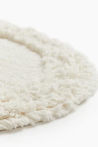 Tapis de bain ovale avec dessus touffeté