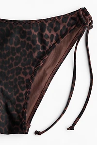 Bas de maillot Tanga échancré à nouer