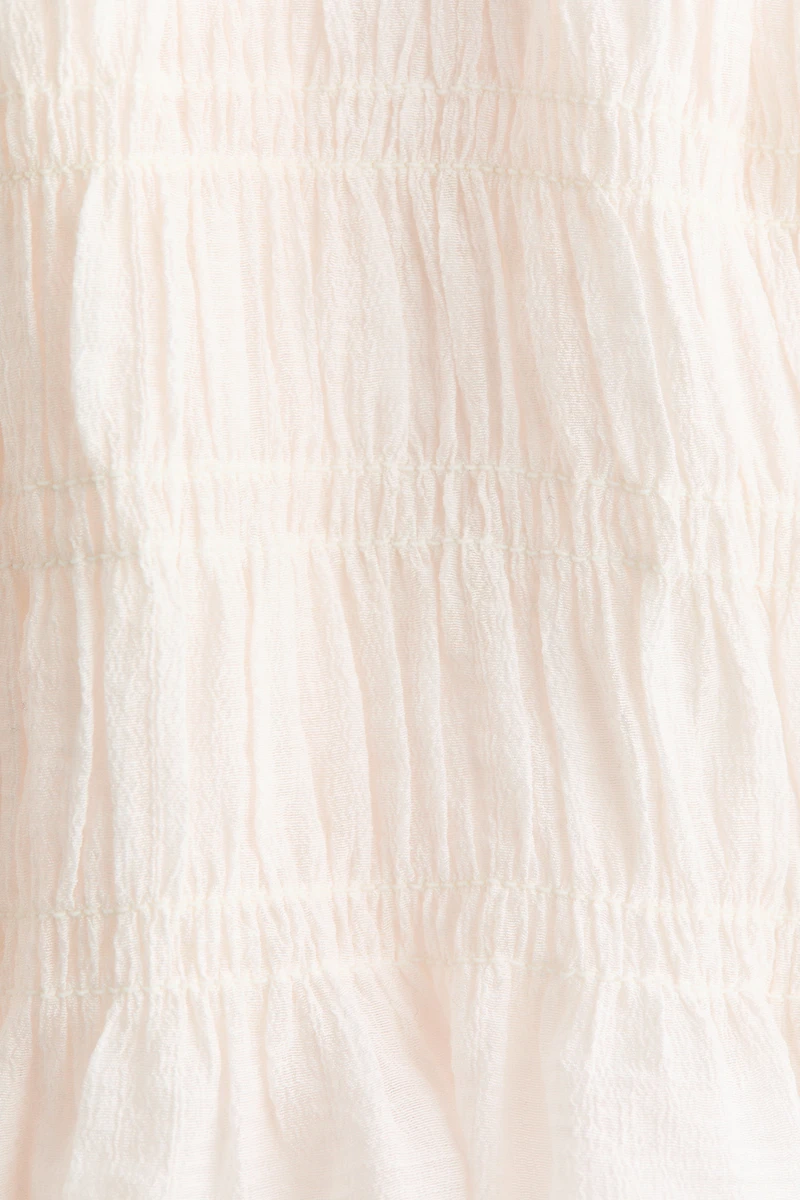 Haut péplum smocké