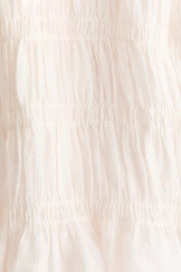 Haut péplum smocké