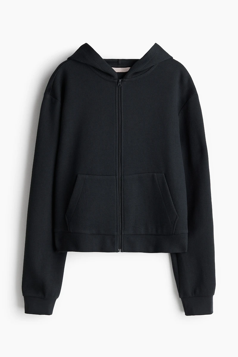 Veste gaufrée avec capuchon et glissière