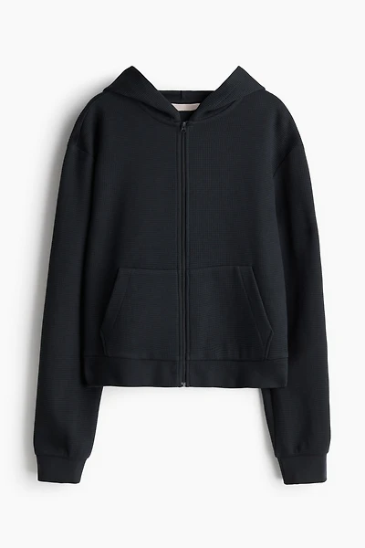 Veste gaufrée avec capuchon et glissière
