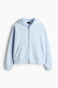 Veste imprimée ample à capuche et fermeture éclair