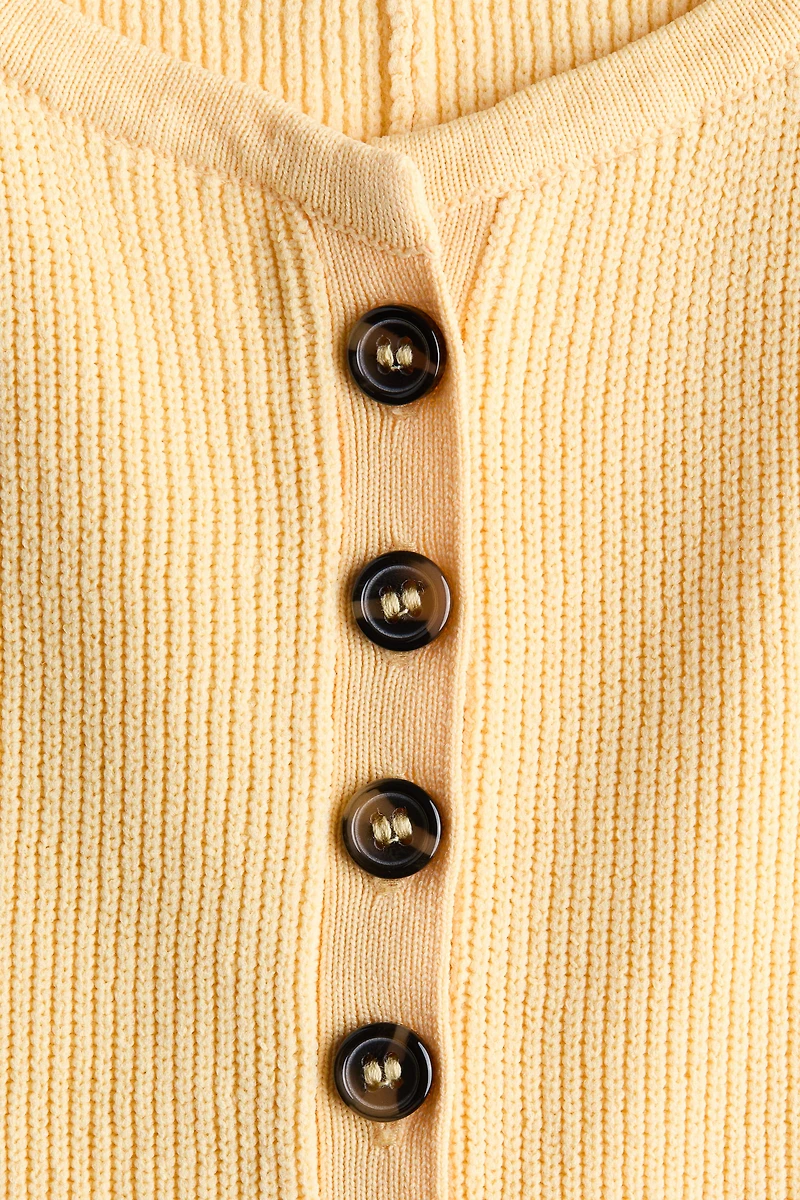 Chandail péplum sans manches en tricot côtelé