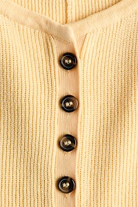 Chandail péplum sans manches en tricot côtelé