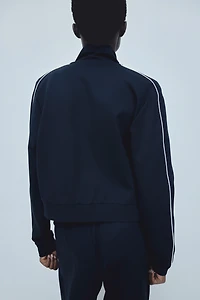 Veste de survêtement avec passepoils