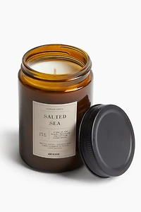 Petite bougie parfumée dans un pot en verre