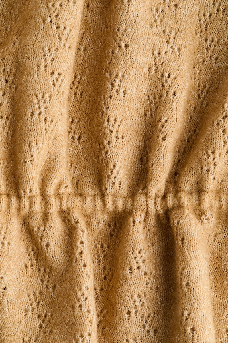 Haut péplum en tricot pointelle