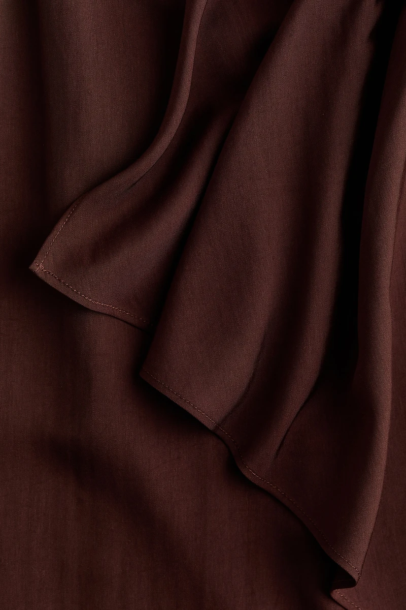 Jupe asymétrique avec panneau drapé