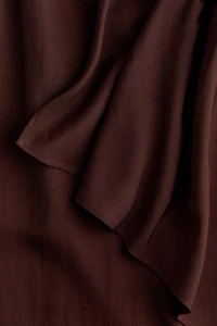 Jupe asymétrique avec panneau drapé