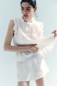 Haut péplum smocké