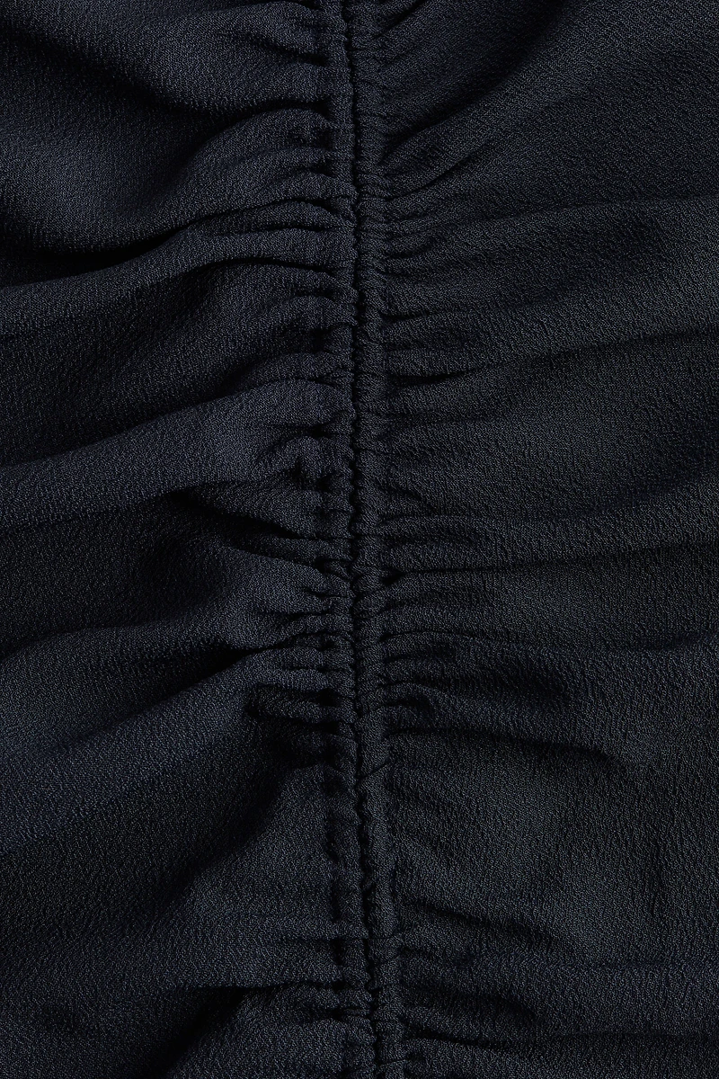 Robe asymétrique à effet drapé