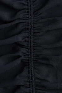 Robe asymétrique à effet drapé