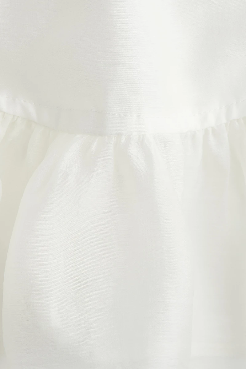 Blouse péplum avec détail à nouer