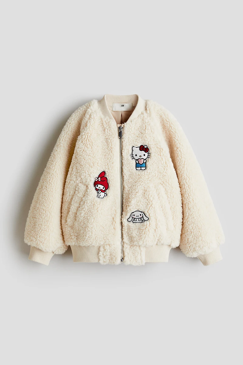 Blouson en tissu polar avec appliqués