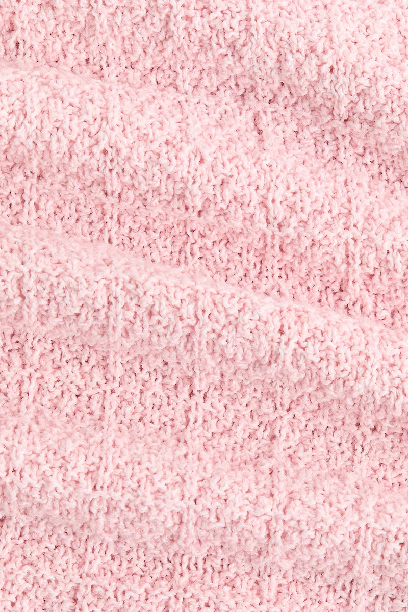 Haut péplum en tricot pointelle