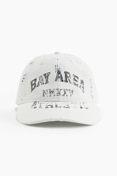 Casquette avec détails fortement usés