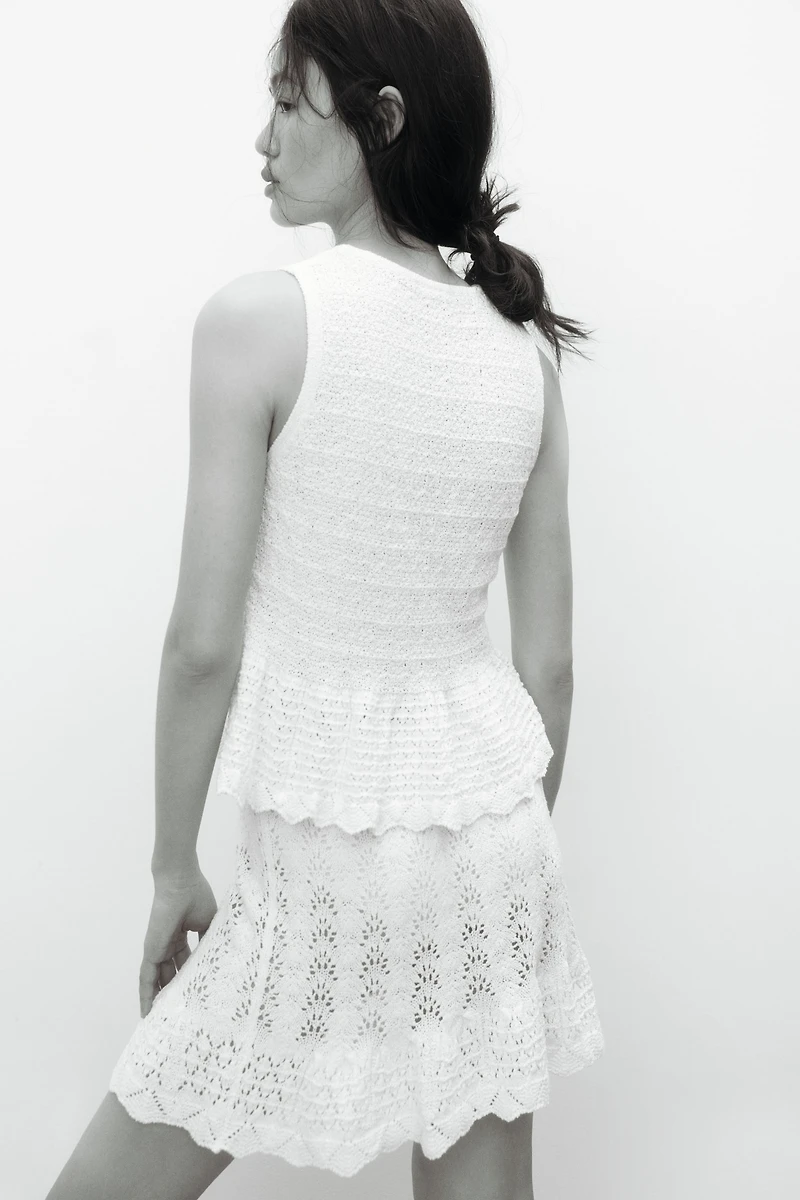 Haut péplum en tricot pointelle