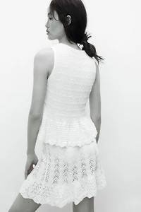 Haut péplum en tricot pointelle