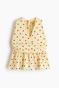 Haut péplum à dos nu