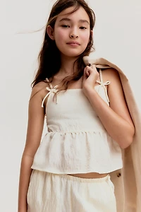 Haut péplum avec boucles