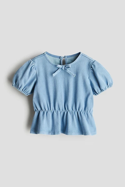 Haut péplum à l'aspect denim