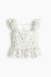 Blouse péplum avec détail à nouer