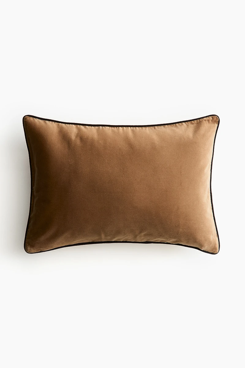 Housse de coussin en velours avec passepoil