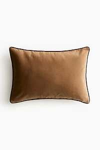 Housse de coussin en velours avec passepoil