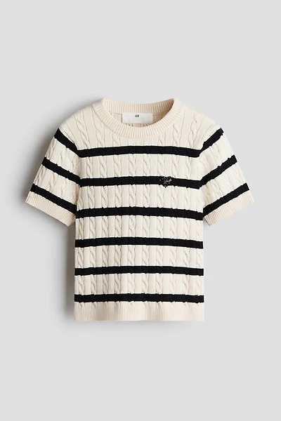 Haut en tricot torsadé