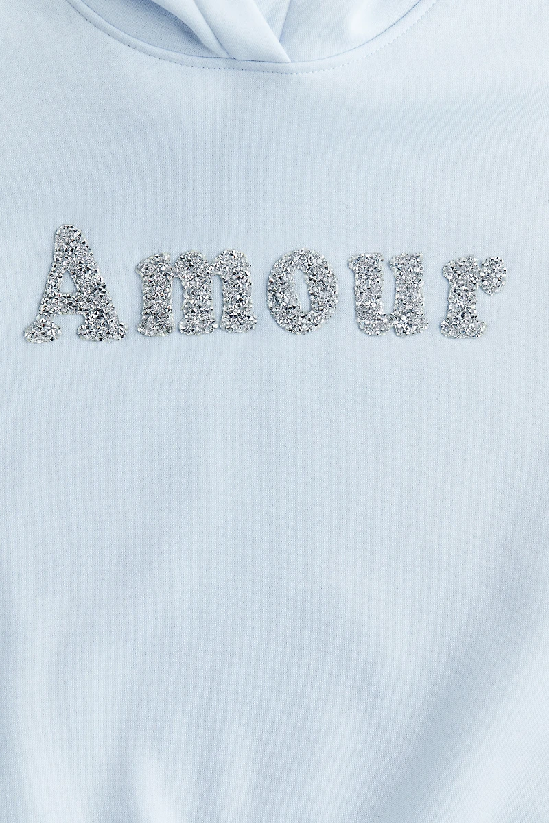 Chandail à capuche ample avec motif