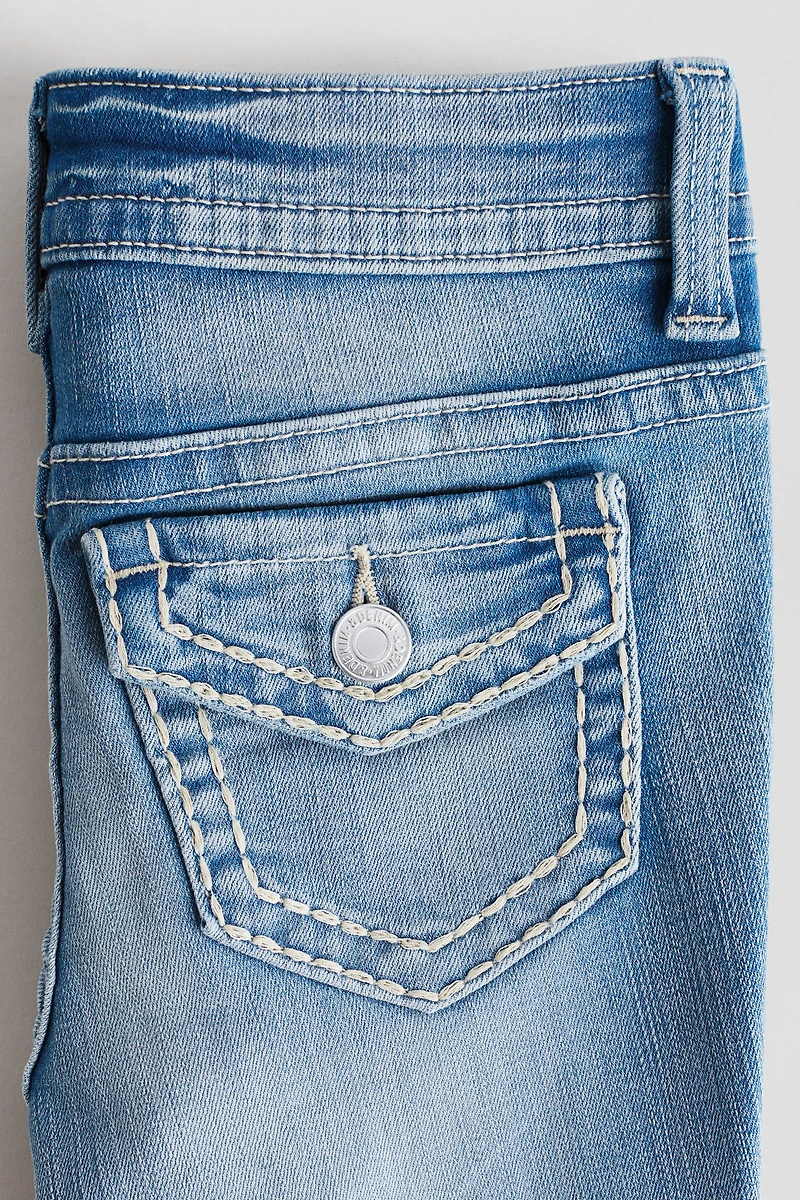 Jean près du corps semi-évasé taille basse