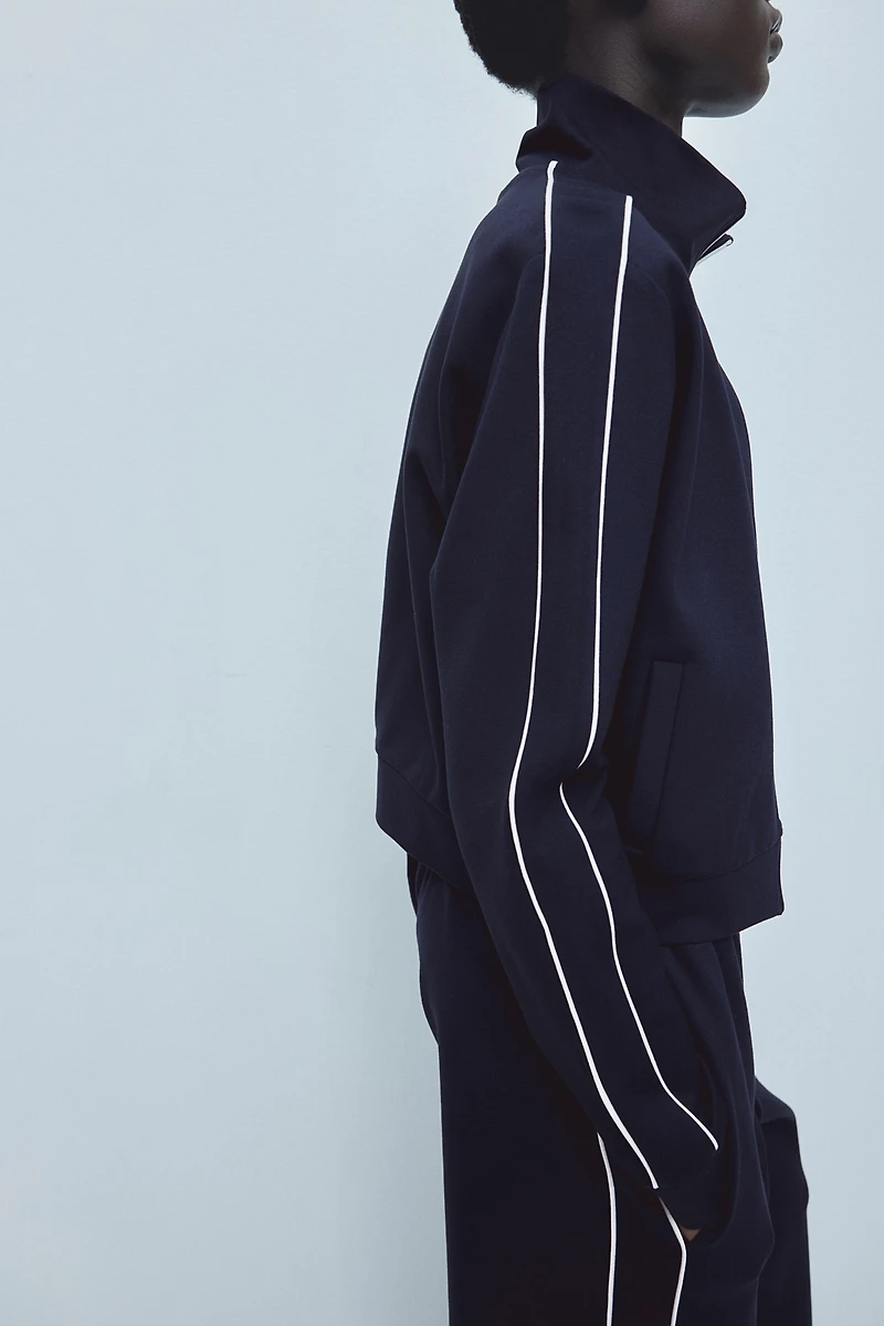 Veste de survêtement avec passepoils