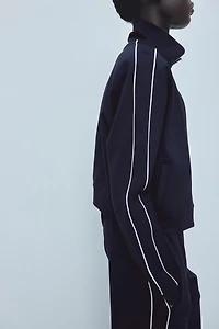 Veste de survêtement avec passepoils