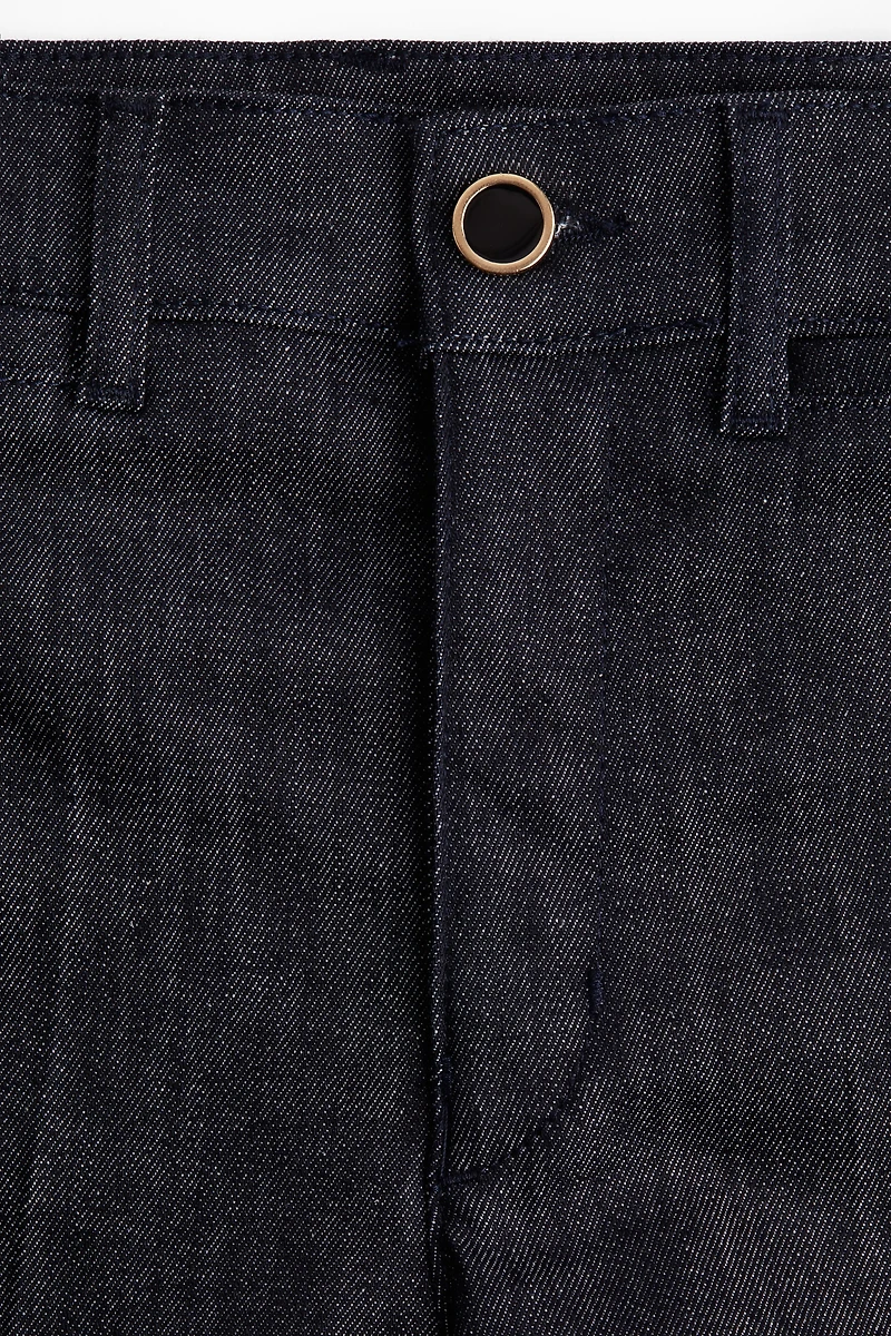 Jean aux chevilles évasé taille haute