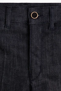 Jean aux chevilles évasé taille haute