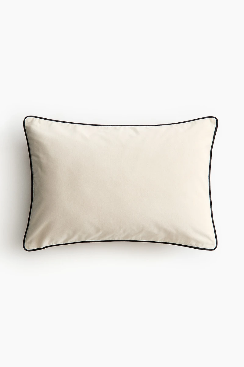 Housse de coussin en velours avec passepoil