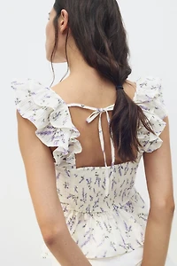 Blouse péplum avec détail à nouer
