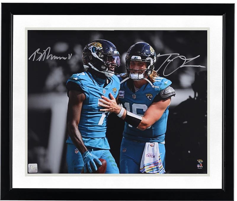 Trevor Lawrence & Brian Thomas Jr. Jacksonville Jaguars Autographed 16" x 20" Teal Jersey Spotlight Photograph