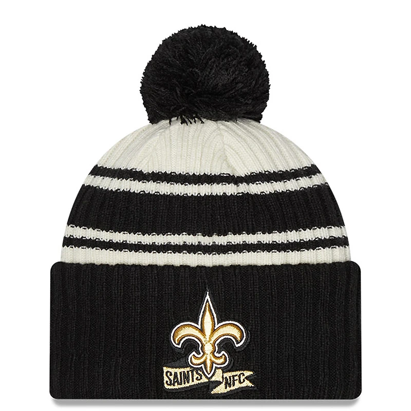 Men's New Era Cream/Black New Orleans Saints 2022 Sideline - Sport Cuffed Pom Knit Hat