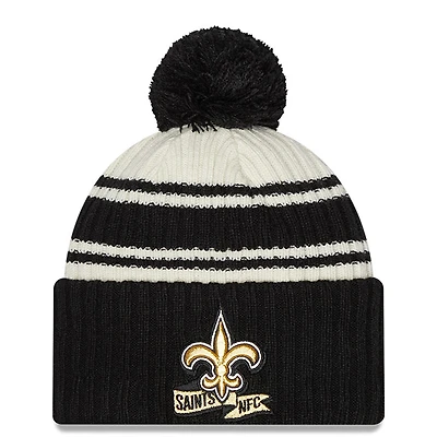 Men's New Era Cream/Black New Orleans Saints 2022 Sideline - Sport Cuffed Pom Knit Hat