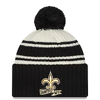 Men's New Era Cream/Black New Orleans Saints 2022 Sideline - Sport Cuffed Pom Knit Hat