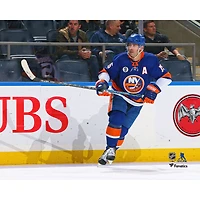 Photographie non signée de Cal Clutterbuck des Islanders New York en train patiner sur la glace