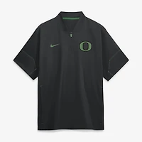 Veste d'entraîneur Nike noire pour homme, collection Oregon Ducks 2026, manches courtes et fermeture éclair au quart.
